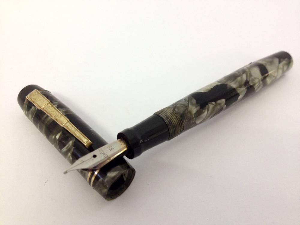 Unique ‘The Unique Pen’ c1950s.Green and black marble with rolled gold trim. Stepped pocket clip,