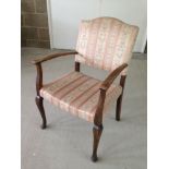 A vintage pink upholstered bedroom chair.