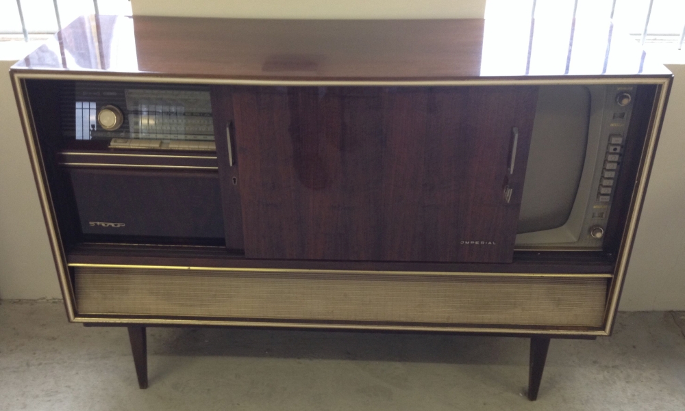 A retro 1963 German Imperial Stromboli 63 stereo radio and VHF TV in polished wood cabinet.
