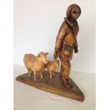 A wooden carving of a shepherd with a sheep & lamb. 40cm tall.