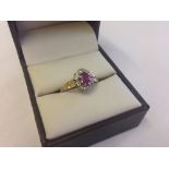 A 9ct gold ruby and diamond cluster style ring, size N.