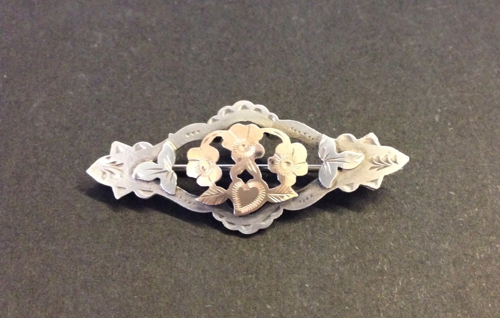 Antique hallmarked silver brooch with rose gold highlights to the central flowers.  Measures 4cm