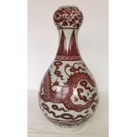 A large oriental vase with brown dragon decoration. 50cm tall.