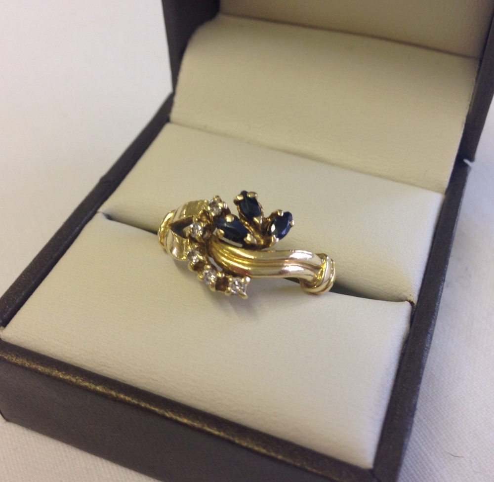 An 18ct gold sapphire & diamond dress ring. Size P 1/2.