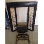 An Art Nouveau cast iron fireplace with tiles to side.