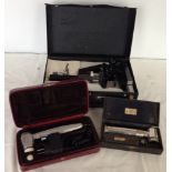 3 cased scientific instruments including microscope.