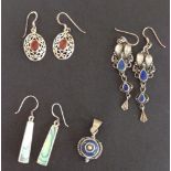 3 pairs of silver earrings and a silver pendant.