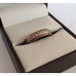 A gold & white sapphire eternity ring - tests as 12ct gold, size M.