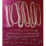 A collection of 7 faux pearl necklaces together with 2 others.