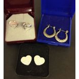 3 pairs of silver earrings, 2 heart shaped & 1 hooped.