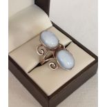 A silver ring set with 2 oval cabouchons. Size approx M.