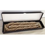 A boxed set of faux pearl jewellery comprising of necklace & bracelet in champagne finish. With 6