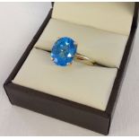 Large Swiss blue topaz solitaire ring. Approx 3ct oval cut stone set in 9ct gold. Size P.