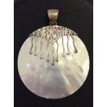 A mother of pearl & 925 silver circular pendant, 2 inch (5cm) diameter.