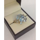 Ladies blue topaz & diamond cocktail ring set in hallmarked 9ct gold. Set with 8 blue topaz stones