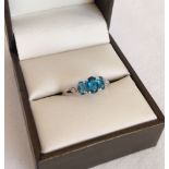 Ladies dress ring in 9ct white gold with 3 London blue topaz stones with 2 diamonds. Size N.