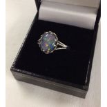 A hallmarked silver ring set with an oval opal cabouchon stone. Size approx S1/2