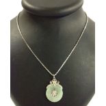 A flat circular Jade & 14ct white gold pendant in a mount on a 20inch 18ct white gold chain. Pendant