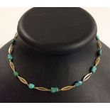 A 14ct gold and turquoise necklace. 16 inches long. Approx 11.1g total weight