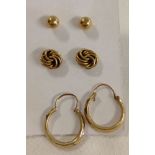 3 pairs of gold earrings comprising: knot design studs test as 15ct, ball stud earrings test as