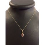 Pretty 9ct gold pendant set with 0.5ct pink sapphire and small diamond. Approx 2.5cm long on a 20"