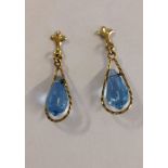 A pair of 9ct gold earrings with blue topaz drops.