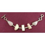 Silver bracelet set with rose quartz stones