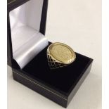 A 9ct gold signet ring with 9ct gold sovereign style disc, size N1/2. Weight approx 3.1g- test as