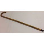 A vintage walking cane equipped with internal rule for measuring horses.