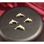 2 pairs of silver dolphin earrings.