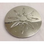 A silver trivet marked Sterling 09, 16cm diameter.