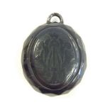 Heavy Victorian oval Whitby jet mourning pendant with hand carved Gothic initials to centre panels