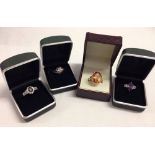 4 pretty dress rings set with various stones and gold plated shanks.