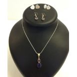 A silver necklace with amethyst pendant together a pair of drop earrings set with amethyst and 2