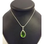 Peridot quartz pear shaped drop pendant on a white metal chain marked 925.