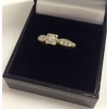 Hallmarked 18ct gold diamond ring set with 7 diamonds - 3 on each shoulder and 1 in a central square