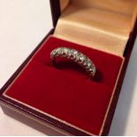 An 18ct gold & diamond half eternity ring set with 7 diamonds. Carat sizes of stones approx .10