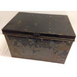 A vintage black tin travelling trunk.