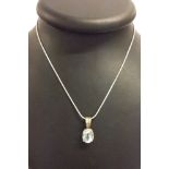 925 silver pendant set with an oval blue topaz stone on a white metal chain marked 925.