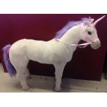 Large freestanding unicorn soft toy.