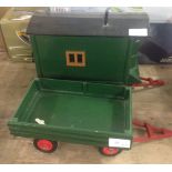 A wooden green painted shepherds hut and trailer. Approx 27cm long excluding tow bar.