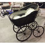 Vintage ornate dolls pram, ideal for doll display. Edged with lace.