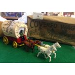 A boxed Morestone lead cowboy covered wagon. Original and complete with driver, 4 horses,