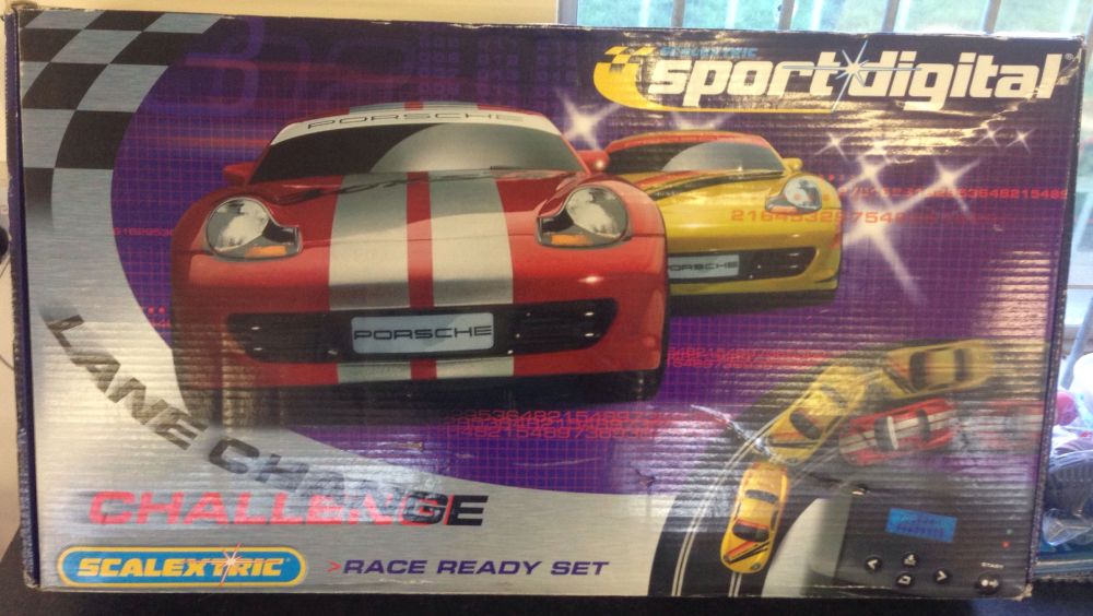 A Scalextric Sport Digital Lane Change Challenge slot car set with 2 Porsche cars.