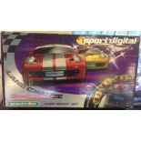 A Scalextric Sport Digital Lane Change Challenge slot car set with 2 Porsche cars.