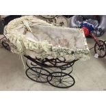 Reproduction antique style dolls pram with lace hood and trim.