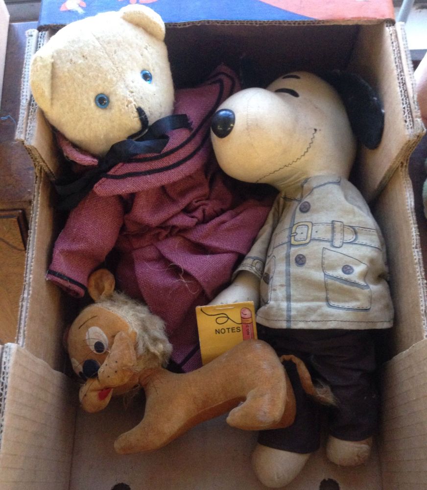 A soft toy Snoopy together with a vintage soft toy lion and a dressed teddy bear.