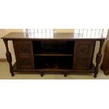 A vintage oak sideboard with carved pedestals and lion head decoration to doors and panels. 7' /