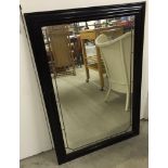 A dark wood framed mirror with applied lead beading. 68 X 99cm