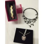 3 pieces of costume jewellery comprising a Rose Quartz pendant, cream wave shaped bangle and a black